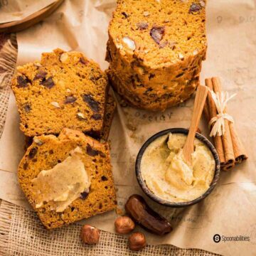 Close up photo of slices of date bread with chunks of chopped hazelnut and dates. Recipe at Spoonabilities.com