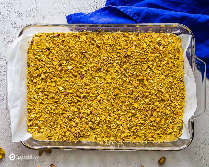 Baking dish with the pistachio cake batter before go into the oven. Recipe at Spoonabilities.com