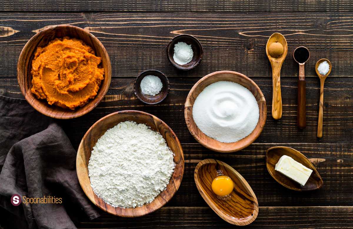 Baking ingredients including pumpkin spice, pumpkin puree, baking powder, baking soda, flour, egg, sugar, salt, vanilla paste and butter