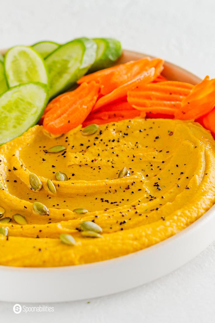 Close up photo of the classic hummus flavored with pumpkin puree. Recipe at Spoonabilities.com