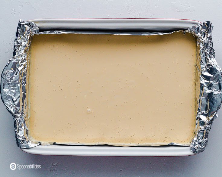 Baking dish linen with tin foil with the cheesecake before go into the oven. Recipe at Spoonabilities.com