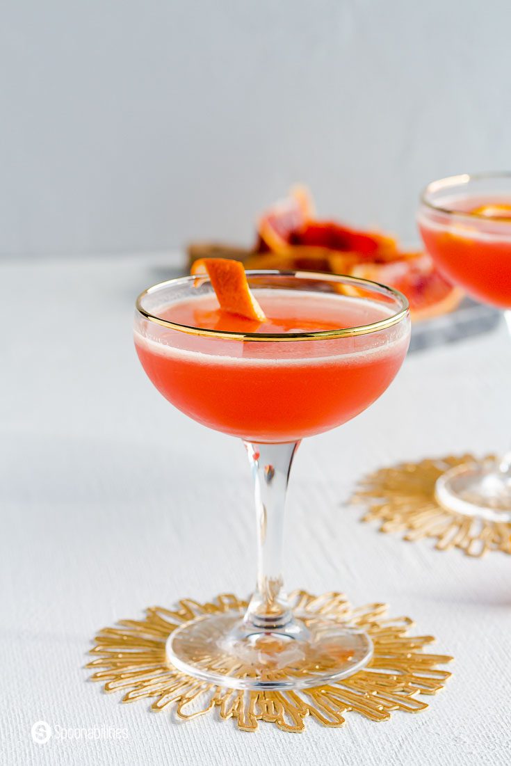 Close up of a coupe glass with Solerno Cocktail and garnished with a blood orange ring. Recipe at spoonabilities.com