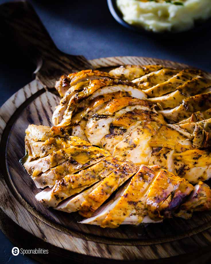 Close up photo showing the golden brown skin from the turkey breast that have been roasted with a mix of red chili brown butter with herbs. Recipe at spoonabilities.com