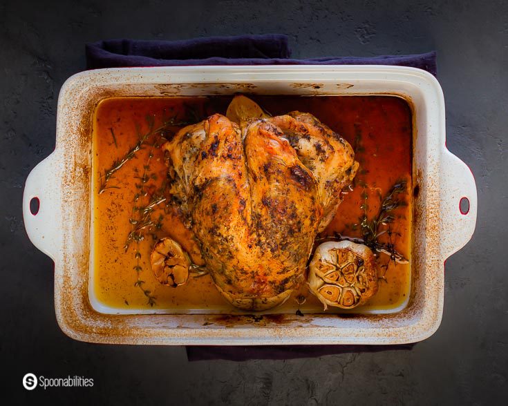 Baking dish with a Chili-herbs roasted turkey breast with a beautiful brown golden color. Recipe at Spoonabilities.com