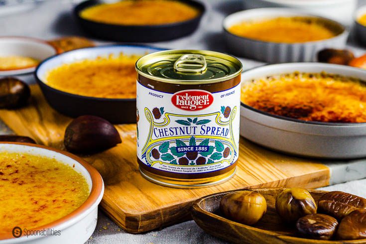 A can of Clément Faugier chestnut spread. This is a top French Gourmet product available at Spoonabilities.com - The can is surround several Crème brûlée in a small ramekins. Recipe at Spoonabilities.com
