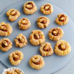 Close-up of the Cashew Thumbprint cookies on a frosted plate. Recipe at Spoonabilities.com