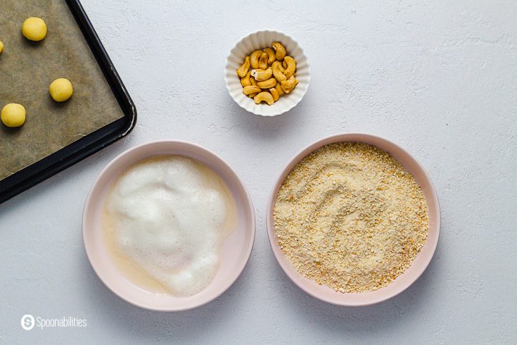 Table set to roll the cashew thumbprint cookies first to a egg white wash, them to a cashew sugar mix. Recipe at Spoonabilities.com