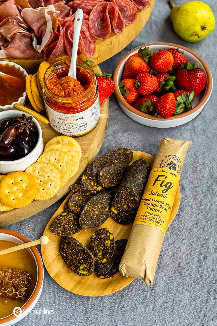 Vegan Fig Salami with Orange Zest and Pepper on a wooden tray as part of a charcuterie board