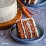 Slice of homemade carrot cake on a blue plate. Learn more about this cake recipe at Spoonabilities.com