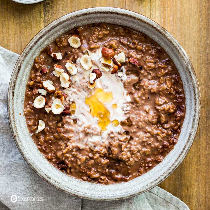 tight close-up of chocolate oatmeal with hazelnut and honey topping