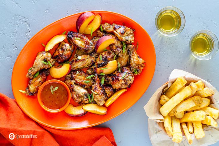 overhead shot of orange dish of chicken wings