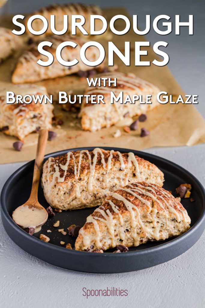 Black round plate with two sourdough scones drizzled with Brown Butter Maple Glaze. Recipe at spoonabilities.com
