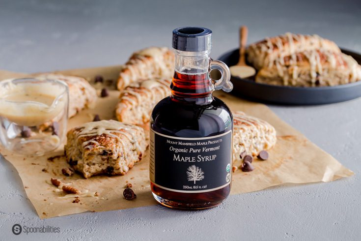 A bottle of Organic Maple syrup and in the background sourdough scones. Recipe at spoonabilities.com