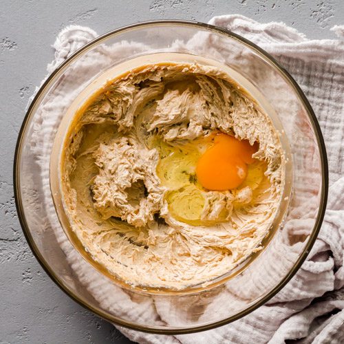 Adding eggs to the cream butter-sugar mix.