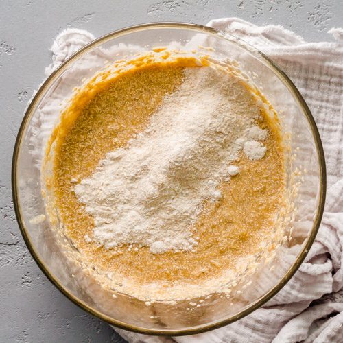 Adding flour to the mixing bowl.