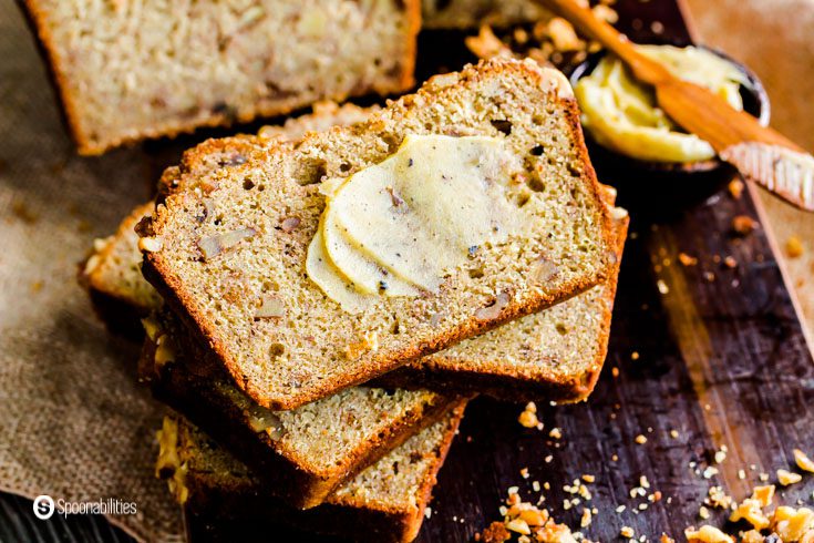 Photo with slices of the banana bread a smear of brown butter. Recipe at Spoonabilities.com