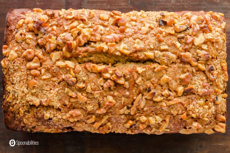 A loaf of the sourdough banana bread from the top showing the crust with nuts. Recipe at Spoonabilities.com