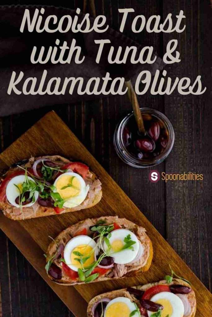 Wood board with 3 slices of Nicoise Toast with Tuna & Kalamata Olives