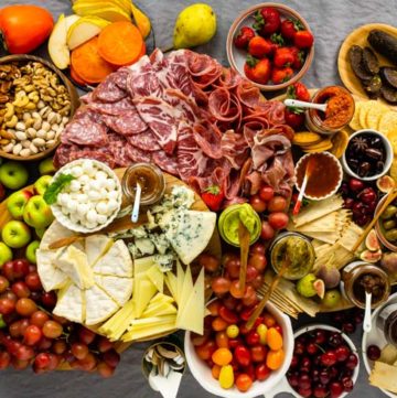 Example of how to make a charcuterie board: Charcuterie board with meat, cheese, produce, and dips.