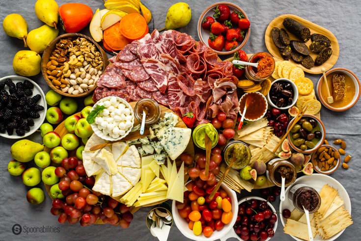 Example of how to make a charcuterie board: Charcuterie board with meat, cheese, produce, and dips.