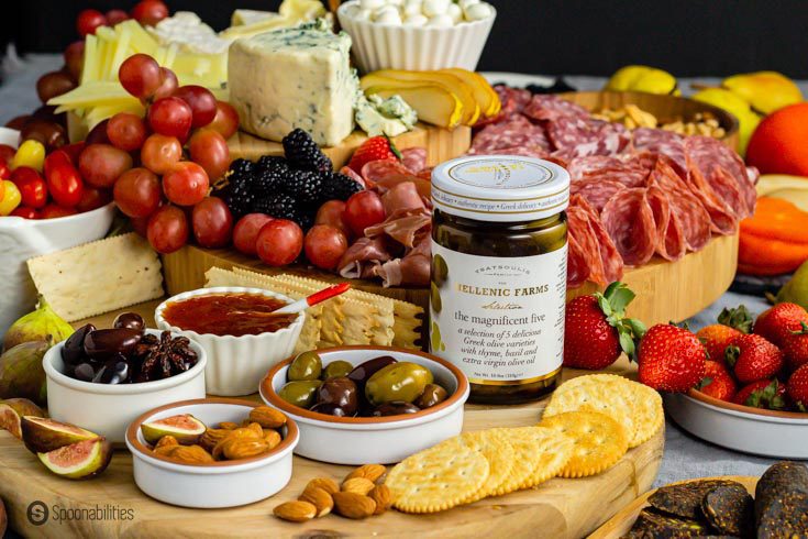 Example of what goes on a charcuterie board: meat, cheese, fruit, olives, jam, and crackers