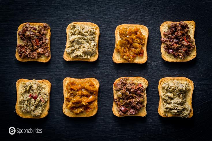 crostini with various toppings shown on a black background