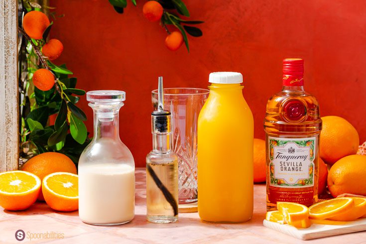 Ingredients for the morir soñando with gin. Evaporated milk, vanilla simple syrup, freshly squeezed orange juice.