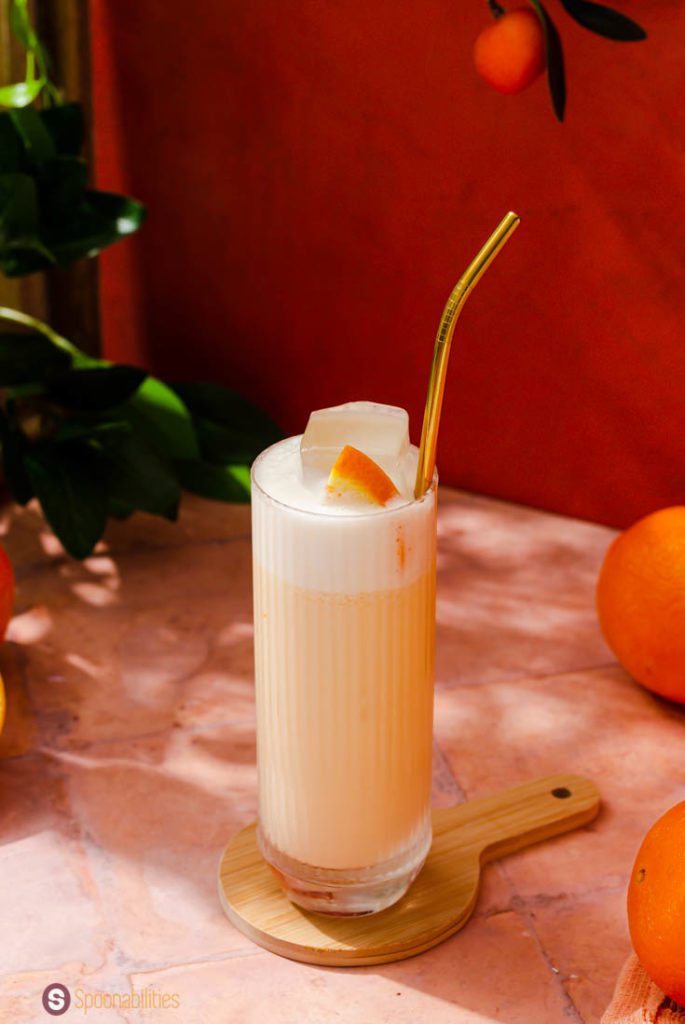 A Close up of the tall glass with Creamsicle Drink with Gin. This drink was inspired by the Dominican drink Morir Soñando.