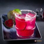 Salt-rimmed rock glass with prickly pear margarita. Recipe at Spoonabilities.com