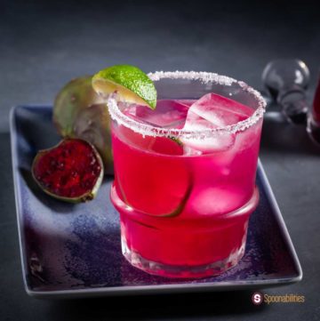 Salt-rimmed rock glass with prickly pear margarita. Recipe at Spoonabilities.com