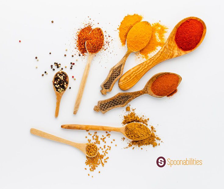 a photo of spices and salts in wooden spoons