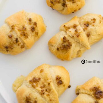 a close up photo of full ham and cheese crescent rolls on a white plate