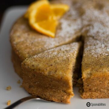 close up photo of sliced Hazelnut Citrus Torte in a white plate