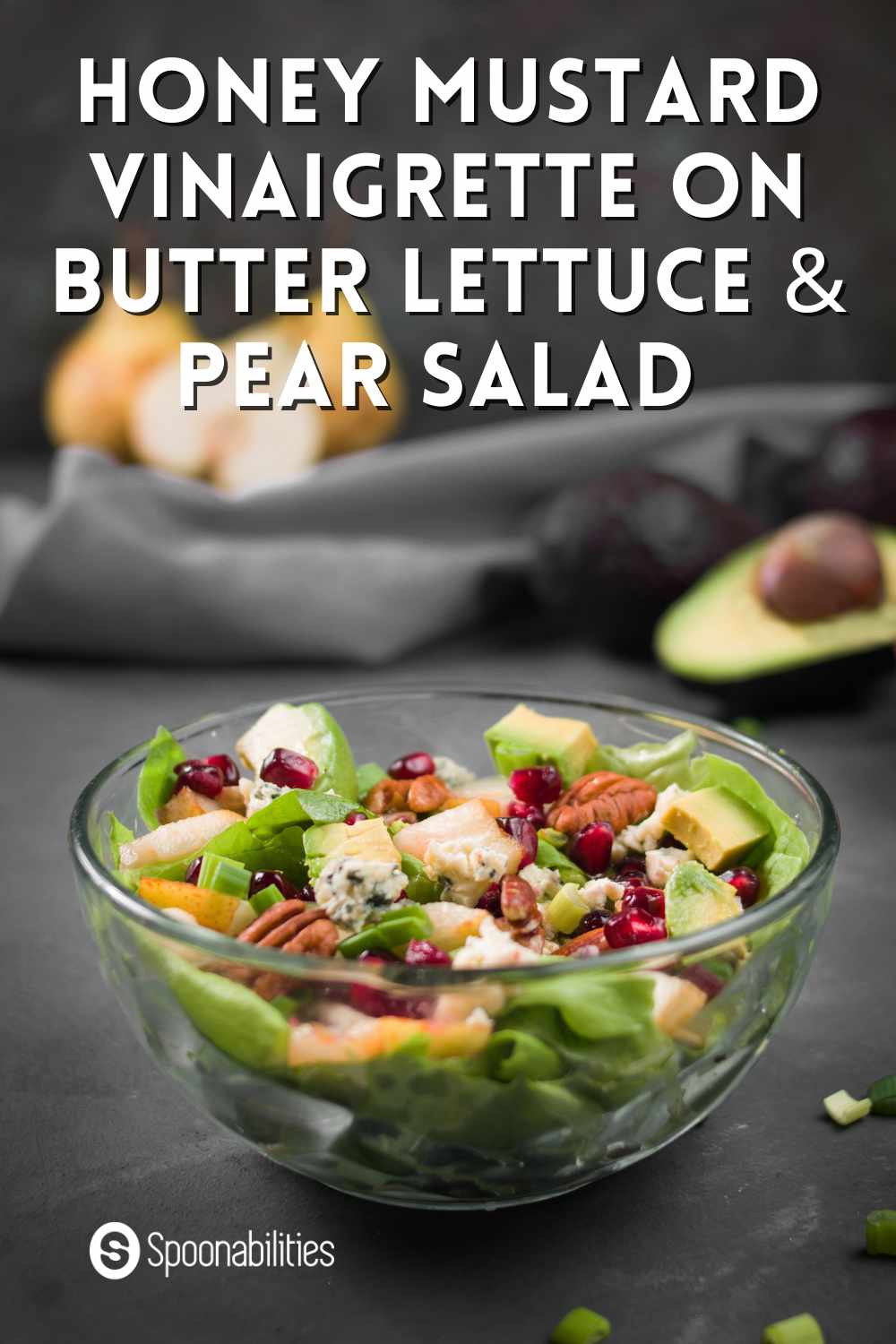 Honey mustard vinaigrette on butter lettuce pear salad in a clear bowl