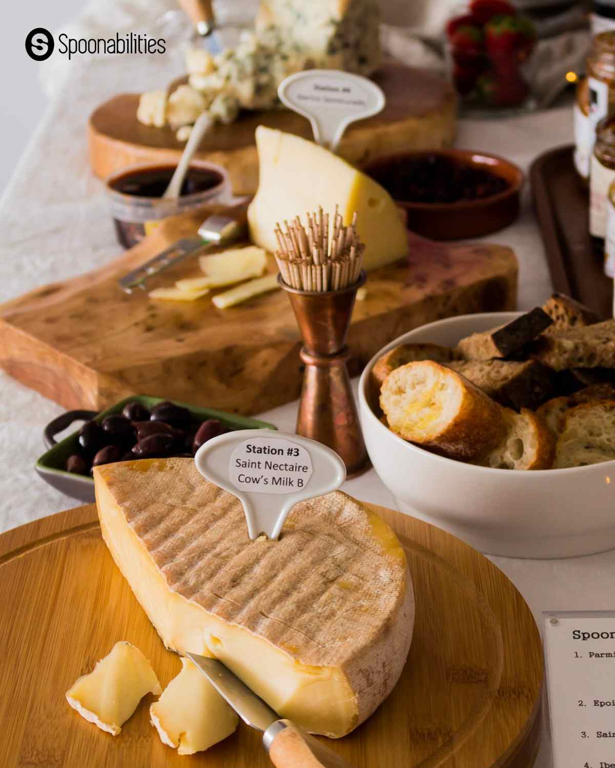 A couple of cheese boards with bread and olives