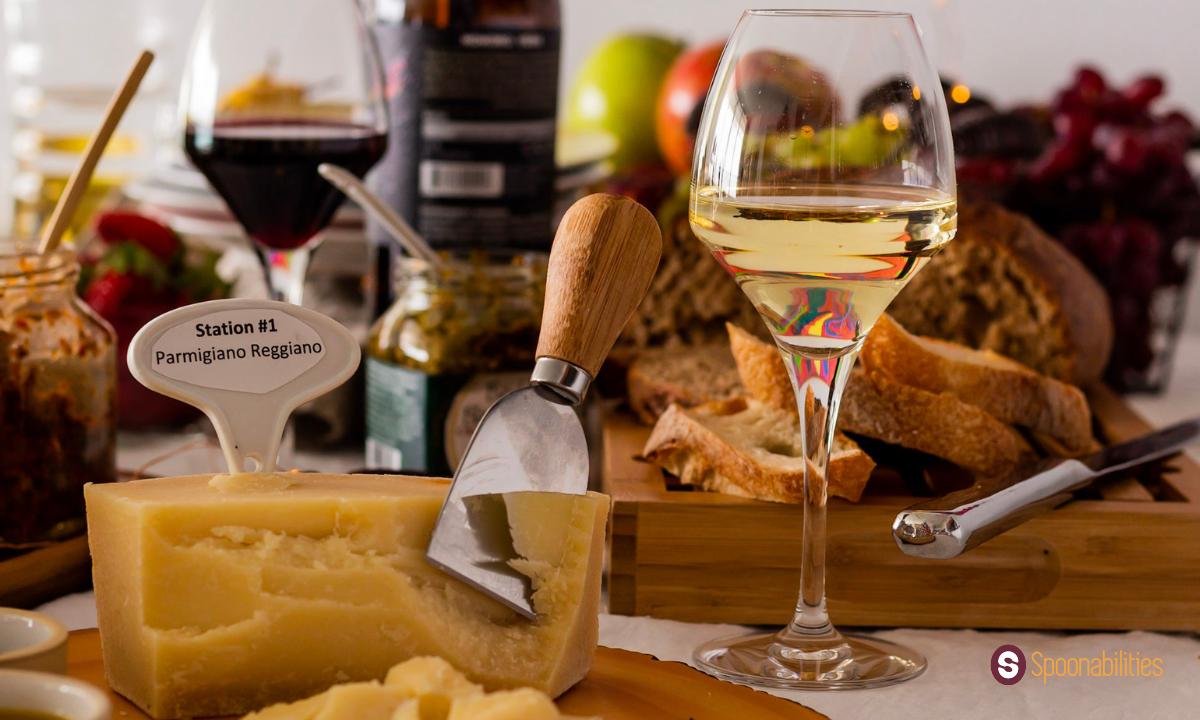 Parmigiano Reggianno block with cheese knife and glass of white wine