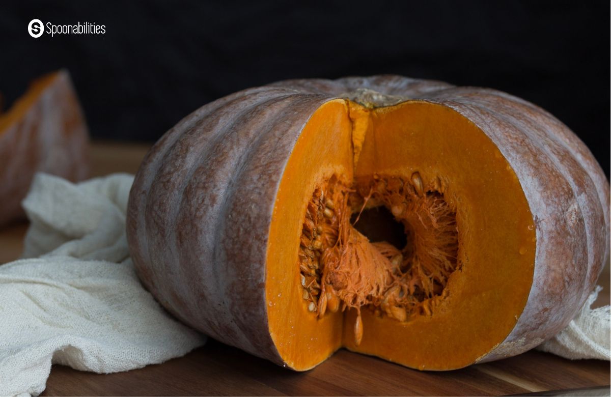 Fresh pumpkin with a wedge sliced from it