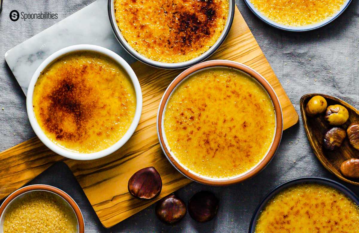 Creamy chestnut creme brulee in ramekins with roasted chestnuts and brown sugar