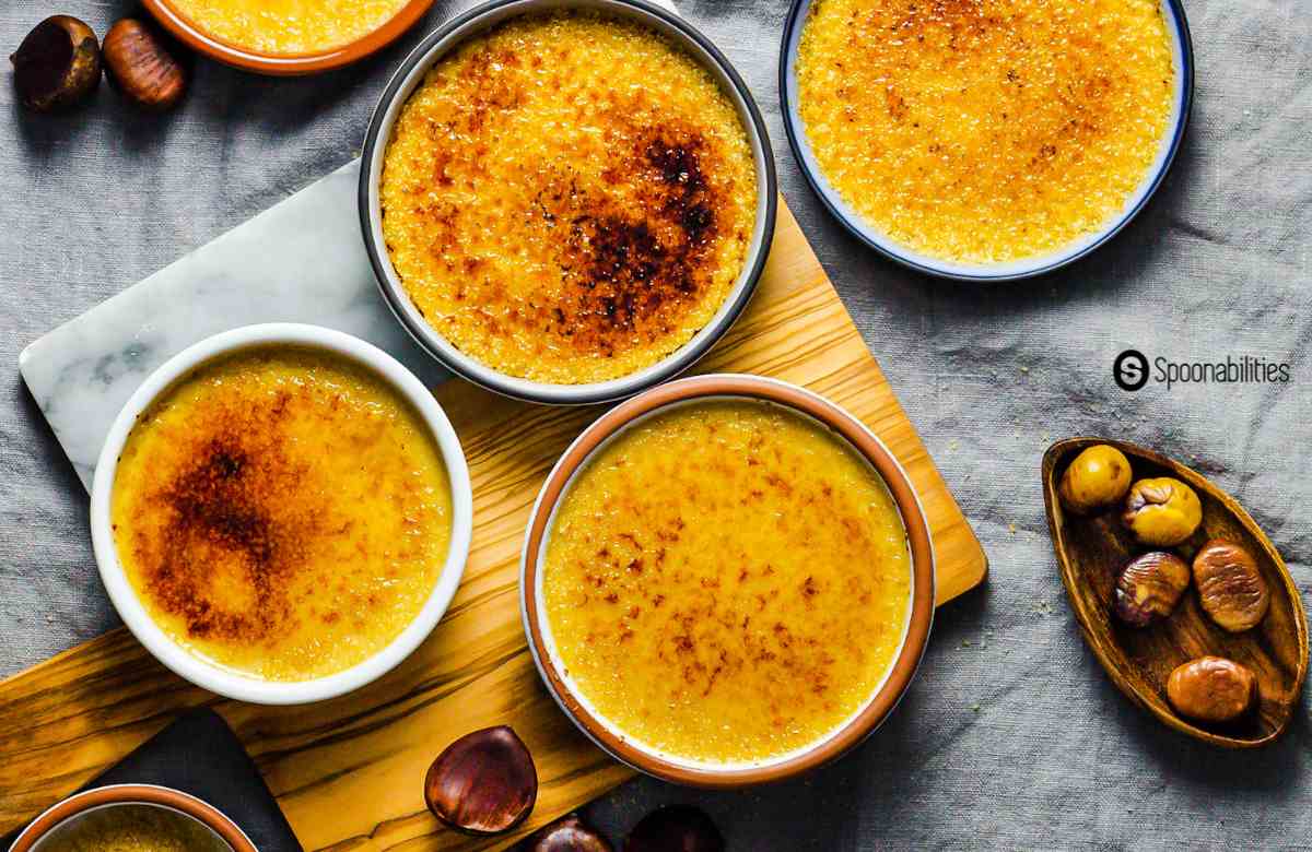 Several small ramekins of chestnut creme brulee with caramelized sugar on top