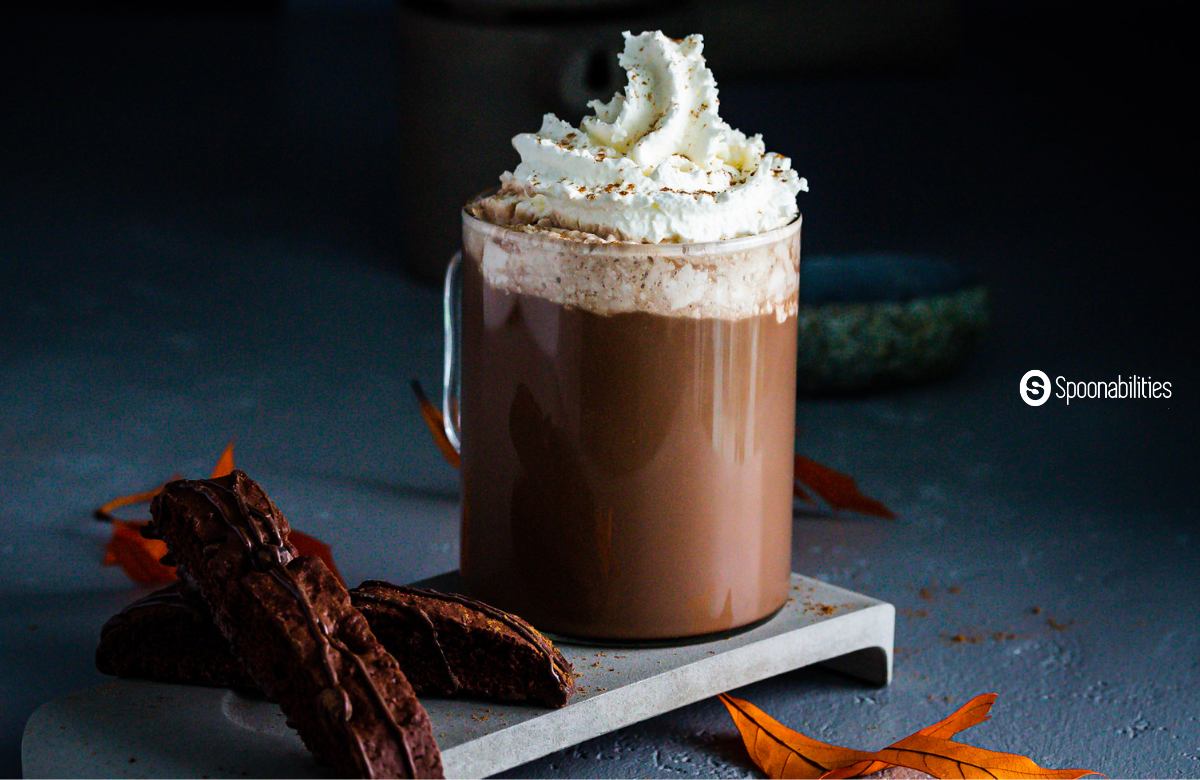 Pumpkin spice mocha in a clear glass mug with whipped cream on top