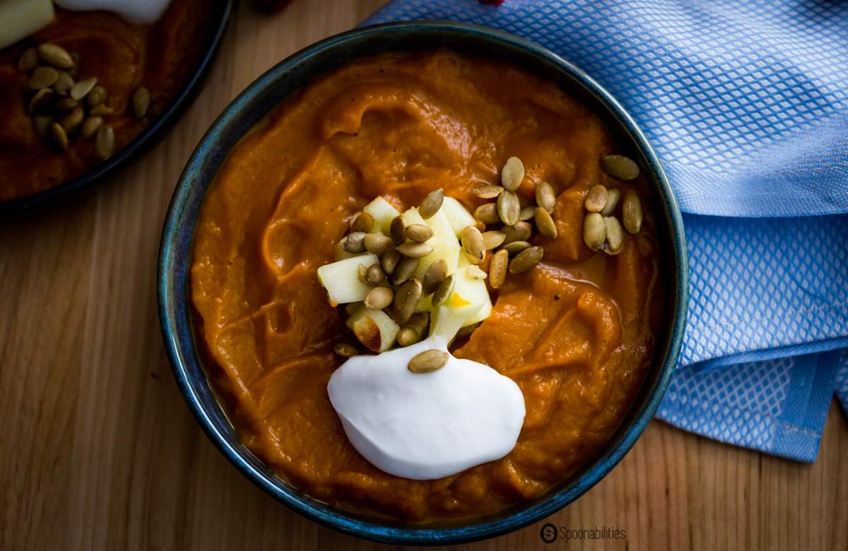 Overhead shot of roasted pumpkin bisque with coconut cream