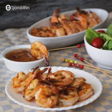 Pan Grilled Shrimp with sauce, bowl of salad and skewers
