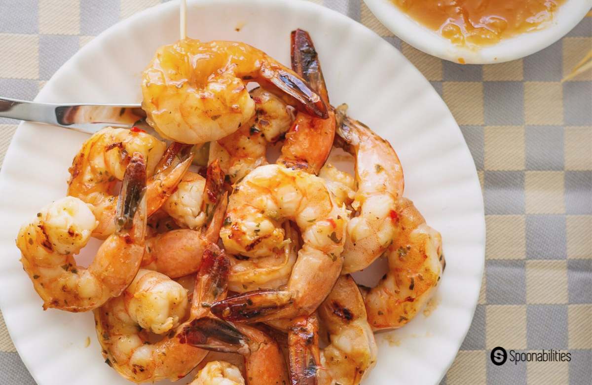 Plate of Spicy and sweet Grilled Shrimp with Roasted Pineapple Habanero Sauce on the side