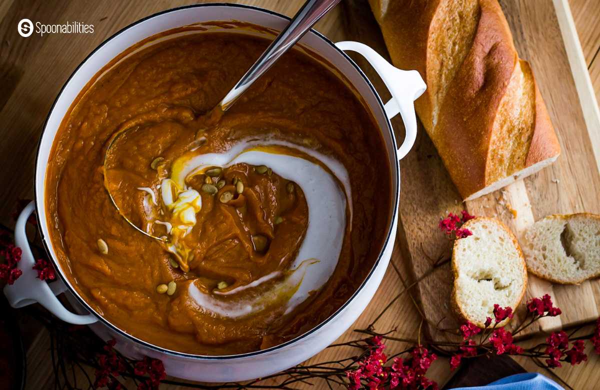 Pot of Pumpkin Bisque with bread on the side