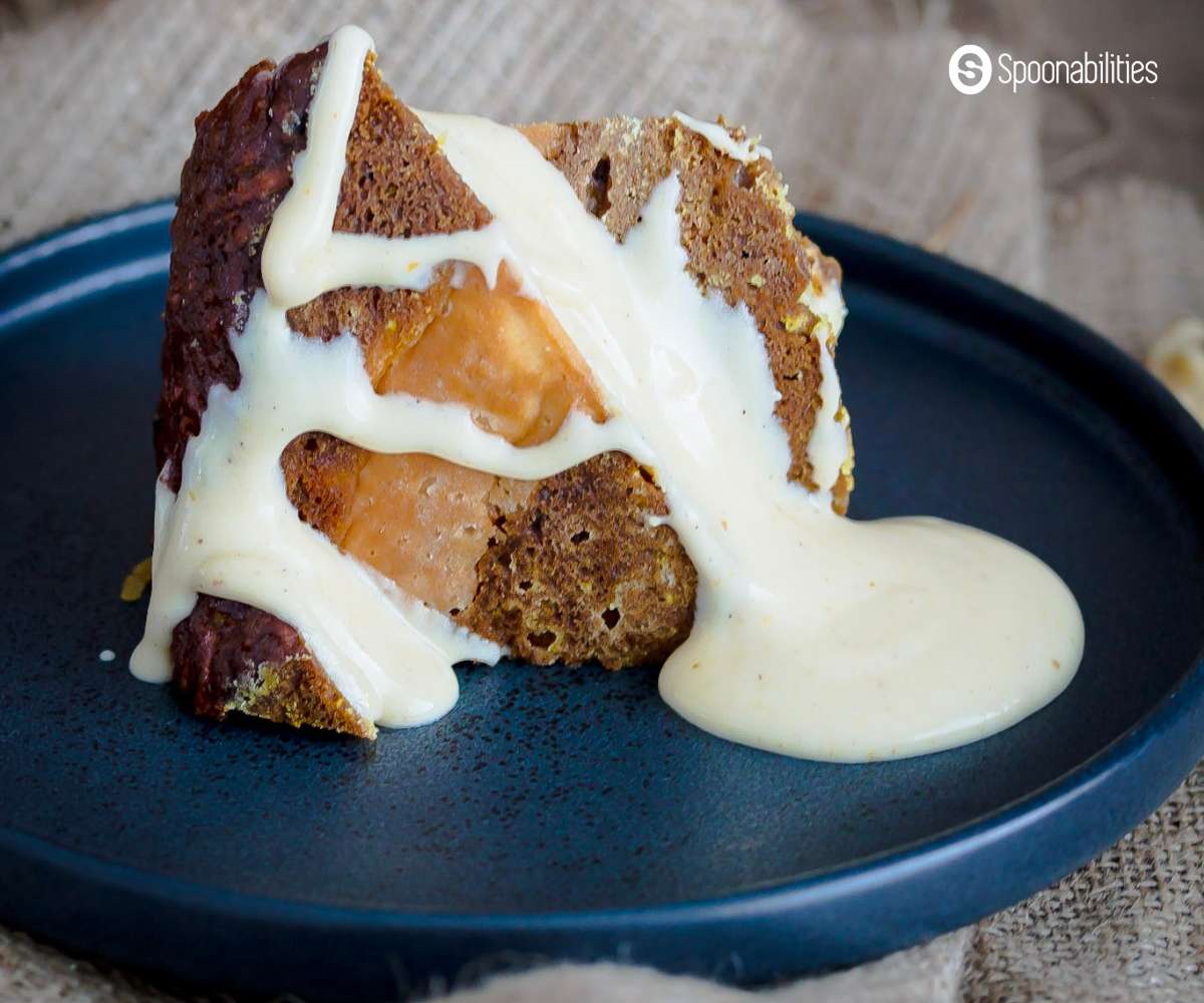 A slice of carrot pumpkin cake with cream cheese sauce