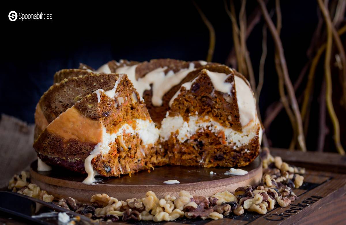 Sliced pumpkin carrot bundt cake showing the cheesecake layer at the center