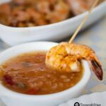 Pan Grilled Shrimp in Roasted Pineapple Habanero Sauce on a tiny saucer