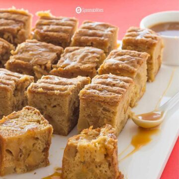 cubed caramel apple blondies with caramel sauce spoon on the side