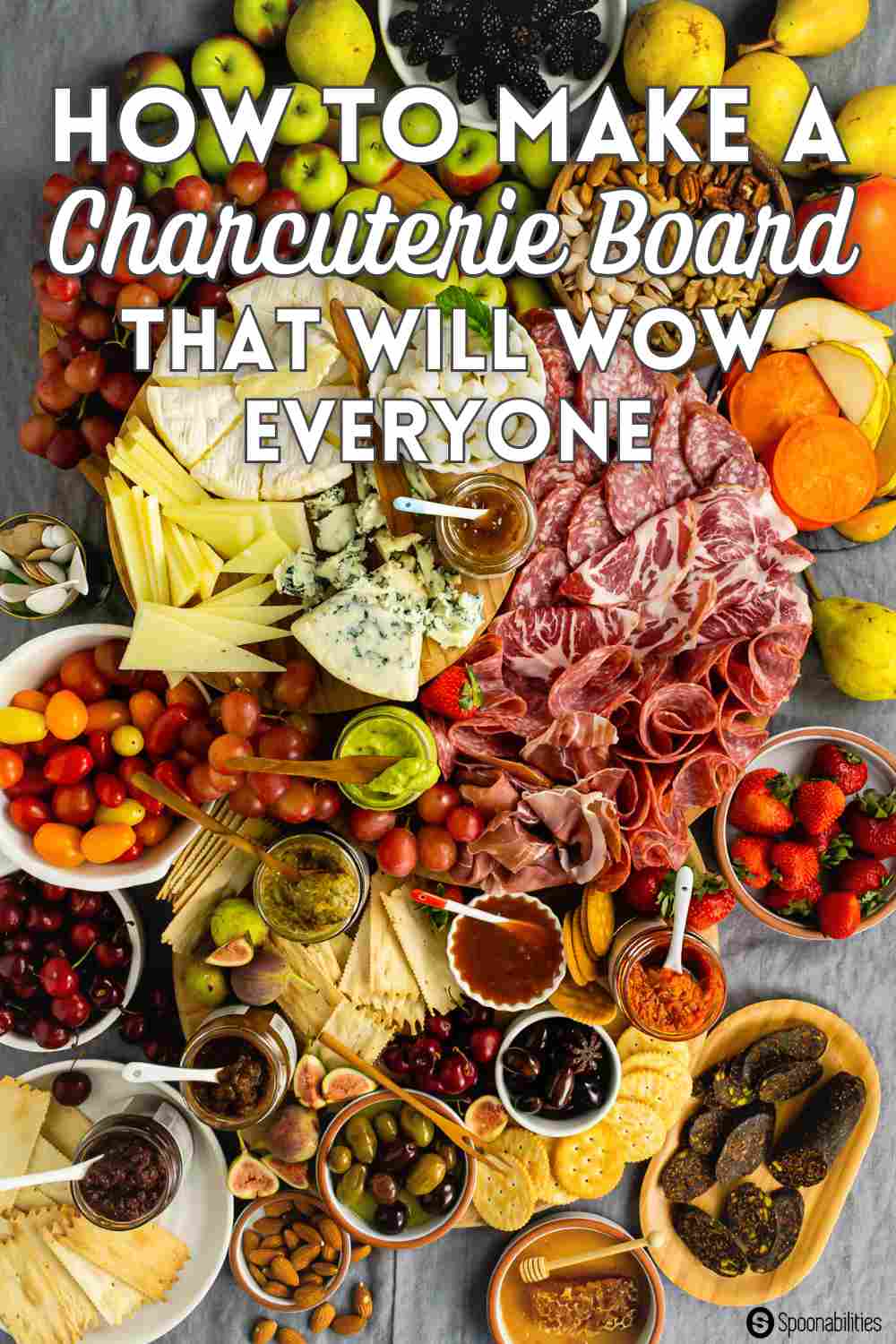 Loaded charcuterie boards with meats, cheeses, fruits, spreads in jars and crackers