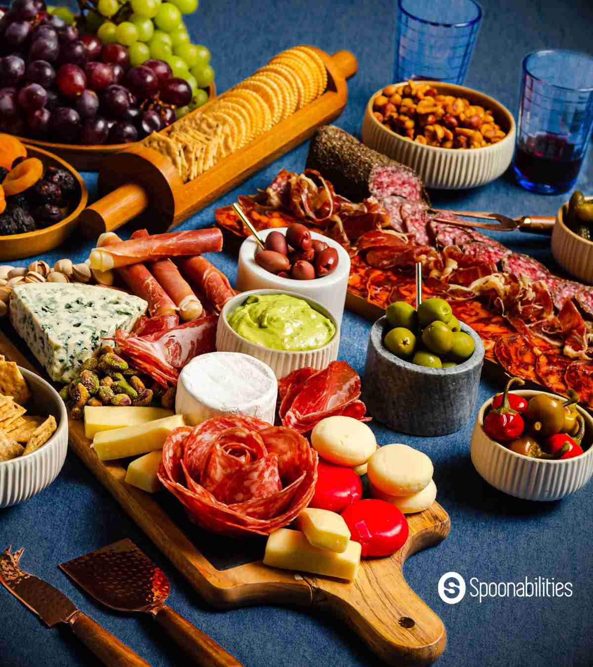 Charcuterie boards with crackers, meat, nuts, cheese, dips and fruits